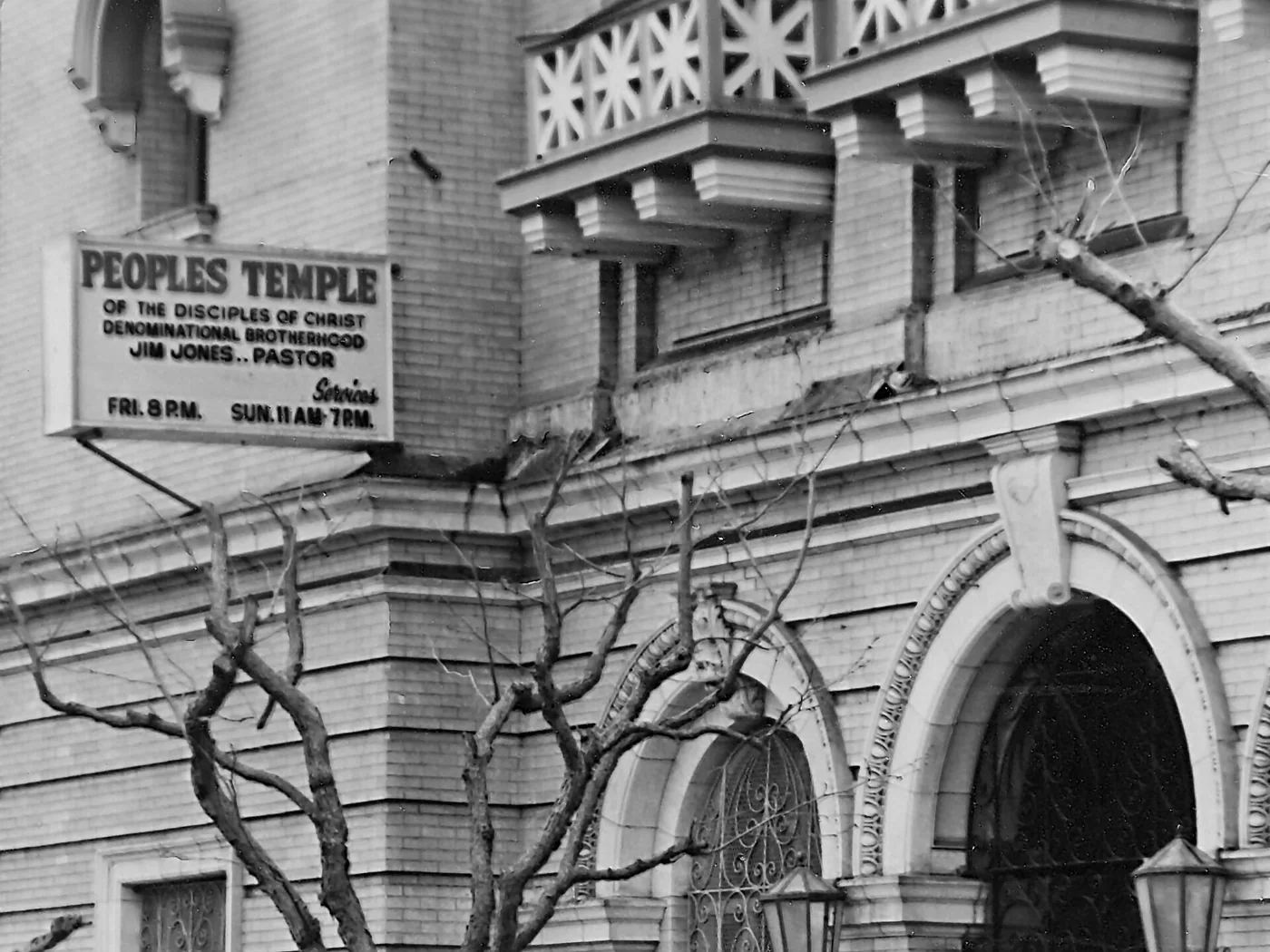 The entrance of the Peoples Temple building at 1859 Geary Boulevard, San Francisco, with a sign listing its services.